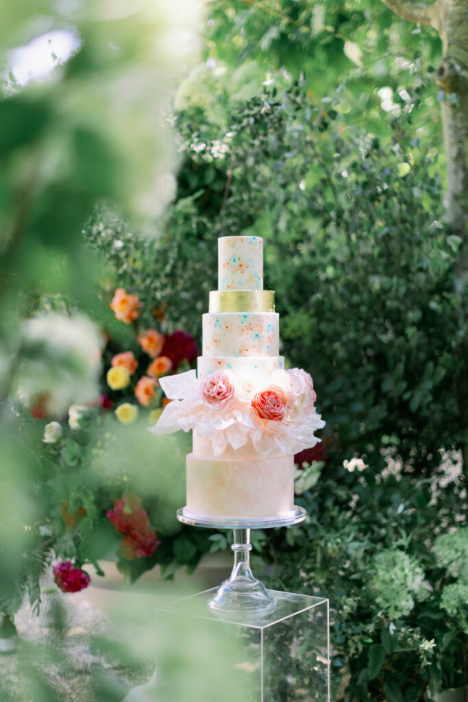 Terre et Lune's six tier hand-painted wedding cake with wafer paper ruffles and handcrafted Juliet rose design.